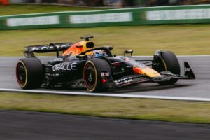 Dynamic shot of a Formula 1 race car speeding at the Interlagos track in São Paulo, Brazil.
